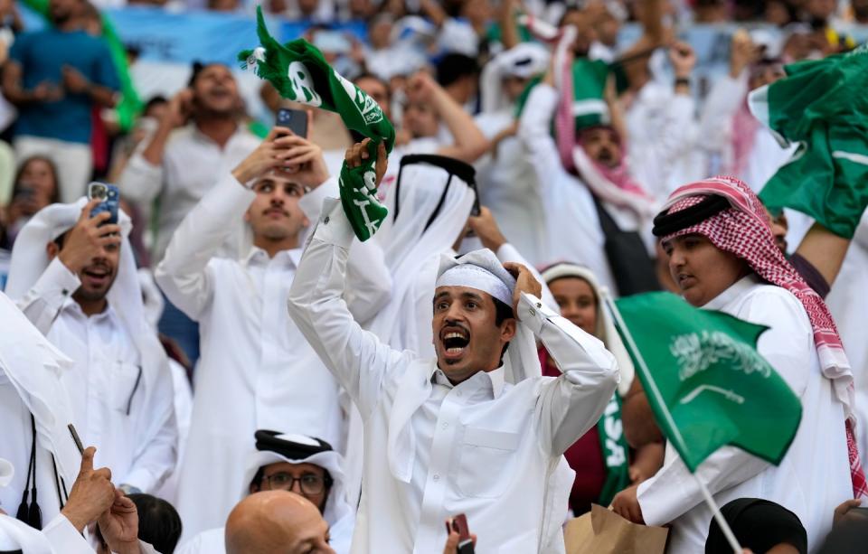 Saudi Arabia fans celebrating after their team scored during the World Cup group C football match between Argentina and Saudi Arabia at the Lusail Stadium in Lusail, Qatar, Tuesday, Nov. 22, 2022. (AP Photo/Natacha Pisarenko)