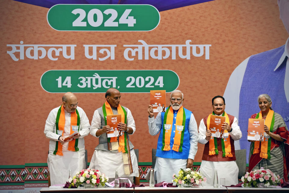 Indian Prime Minister Narendra Modi, center, releases his ruling Bharatiya Janata Party's manifesto for the upcoming national parliamentary elections in New Delhi, India, Sunday, April 14, 2024. Standing from L to R with him are BJP's senior leaders Home Minister Amit Shah, Defence Minister Rajnath Singh and Party President JP Nadda, and Finance Minister Nirmala Sitharaman. (AP Photo/Manish Swarup)