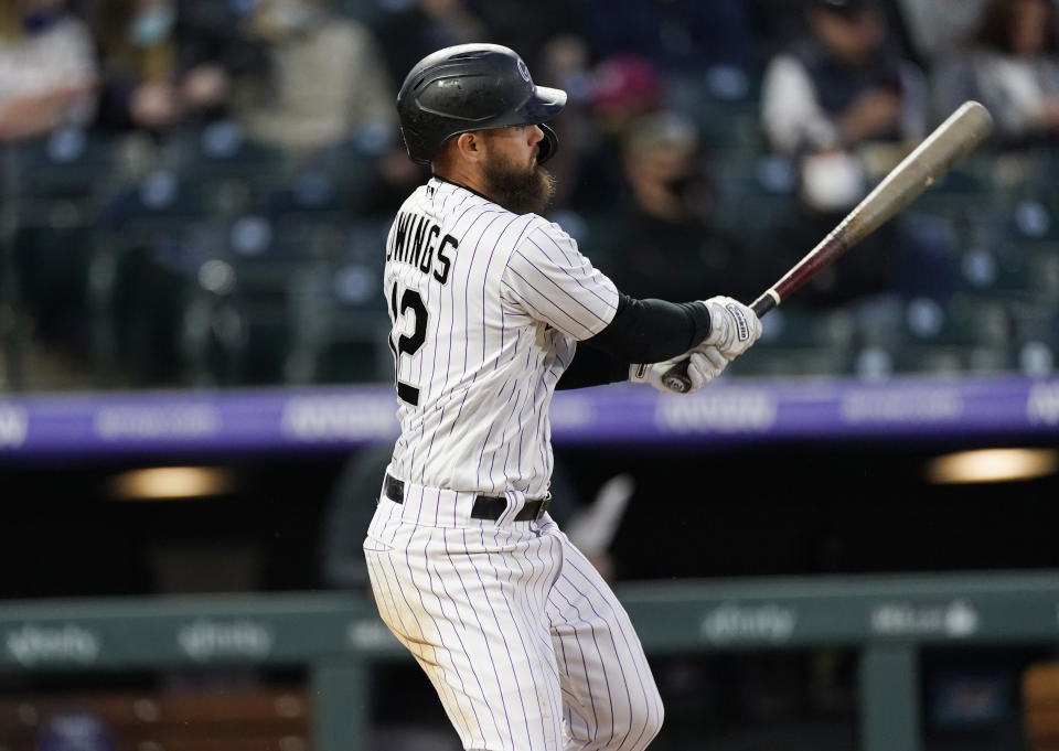 Colorado Rockies' Chris Owings watches his double off Arizona Diamondbacks starting pitcher Madison Bumgarner during the third inning of a baseball game Wednesday, April 7, 2021, in Denver. (AP Photo/David Zalubowski)