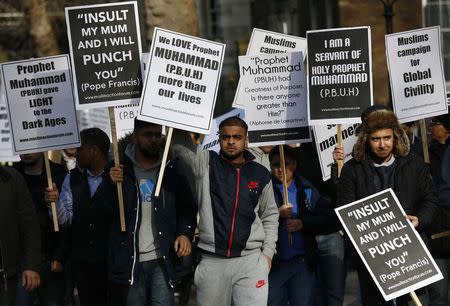 Muslim demonstrators hold placards during a protest against the publication of cartoons depicting the Prophet Mohammad in French satirical weekly Charlie Hebdo, near Downing Street in central London February 8, 2015. REUTERS/Stefan Wermuth