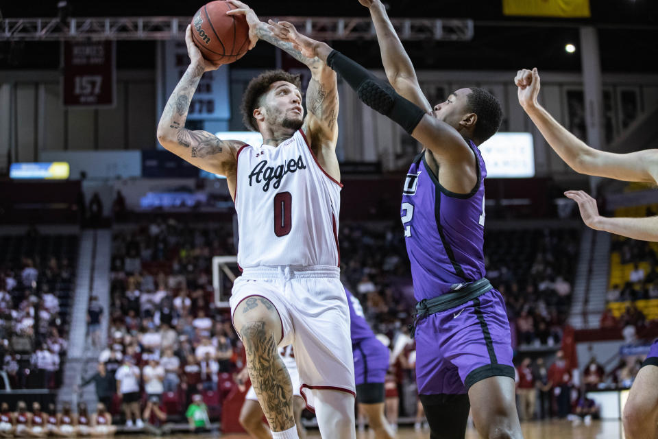 Teddy Allen (0) shoots the ball as the New Mexico State Aggies face off against the Abilene Christian Wildcats at the Pas American in Las Cruces on Saturday, Jan. 15, 2022.