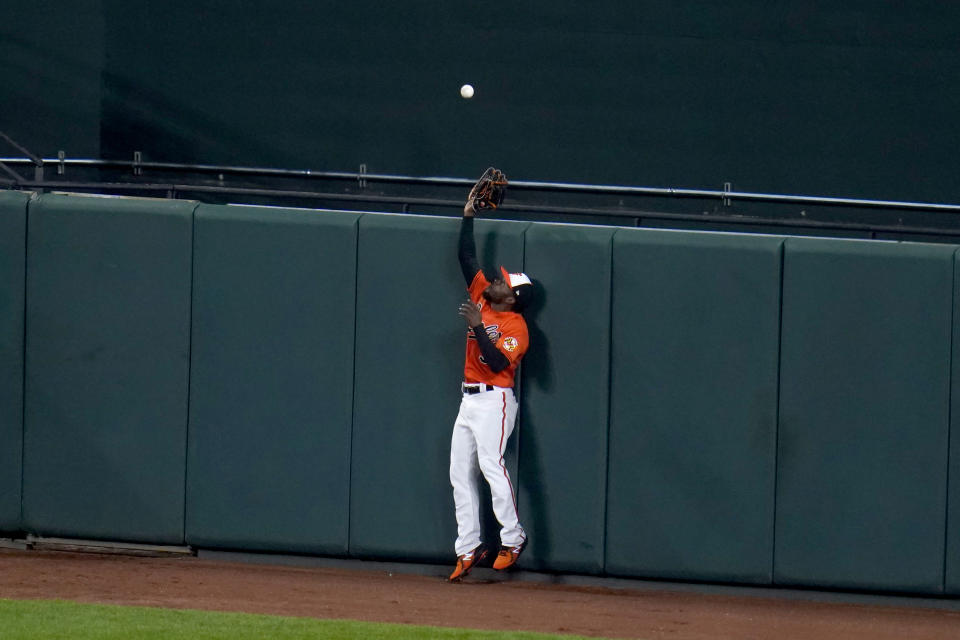 Baltimore Orioles center fielder Cedric Mullins goes up to make a warning track catch on a ball hit by Boston Red Sox's Enrique Hernandez during the fifth inning of a baseball game, Saturday, April 10, 2021, in Baltimore. (AP Photo/Julio Cortez)