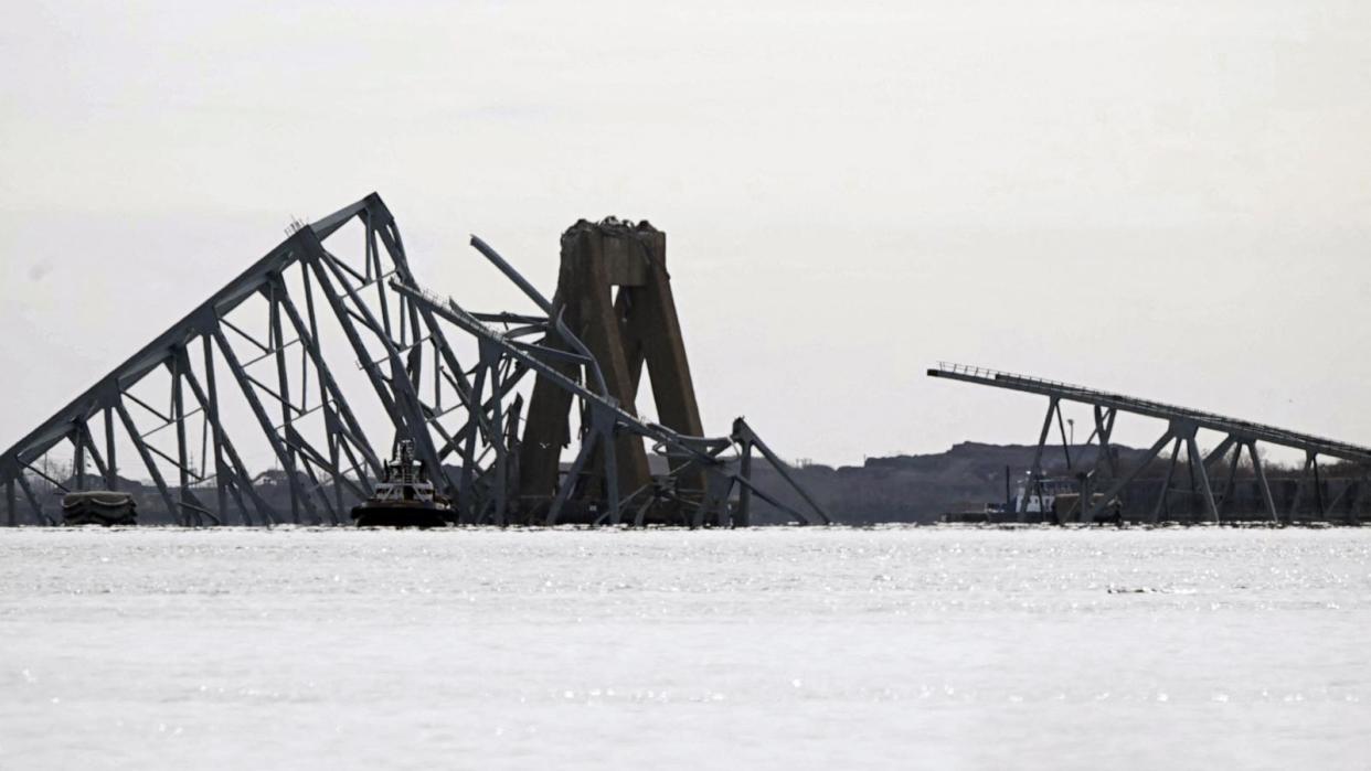 PHOTO: The steel frame of the Francis Scott Key Bridge lies in the water after it collapsed in Baltimore, March 26, 2024. (Mandel Ngan/AFP via Getty Images)