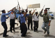 Iraqi security forces celebrate during the withdrawal of U.S. troops in Baghdad June 30, 2009. U.S. combat troops left the last of Iraq's cities on Tuesday, restoring to the country a proud sense of sovereignty that many applauded even though some fear it may leave them more vulnerable to attacks. REUTERS/Ahmed Malik