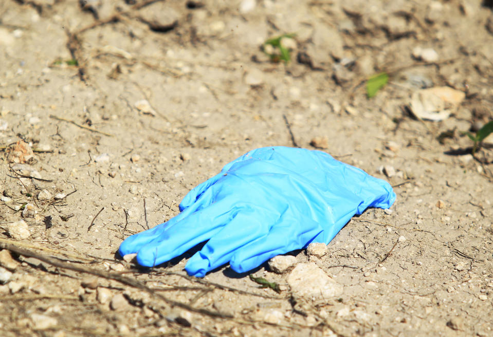 A forensic glove is located in the crime scene after a U.S. Border Patrol kidnapped and assaulted three immigrants from Honduras Thursday March 13, 2014, in Mission, Texas. Esteban Manzanares shot himself in the head killing himself before FBI agents entered his apartment. (AP Photo/The Monitor, Gabe Hernandez)