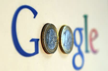 An illustration picture shows a Google logo with two one Euro coins, taken in Munich, Germany in this January 15, 2013 file photo. REUTERS/Michael Dalder