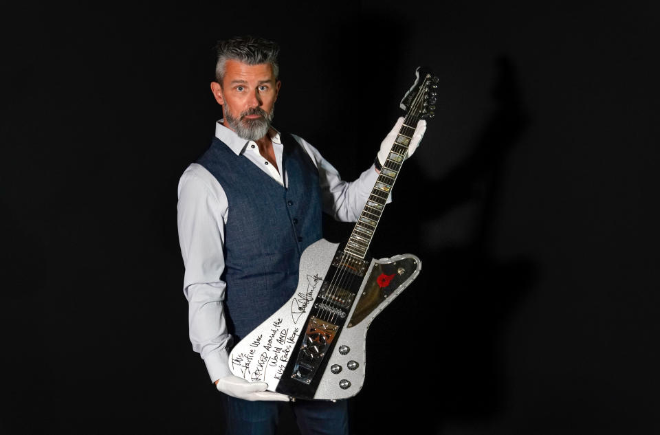 Propstore CEO Stephen Lane holds a Paul Stanley from KISS autographed and inscribed stage used custom silver glitter Washburn Starfire guitar (estimate £40,000 - 80,000) during a preview for the Entertainment Memorabilia Auction, at the Propstore in Rickmansworth, Hertfordshire. Picture date: Wednesday September 20, 2023. (Photo by Andrew Matthews/PA Images via Getty Images)