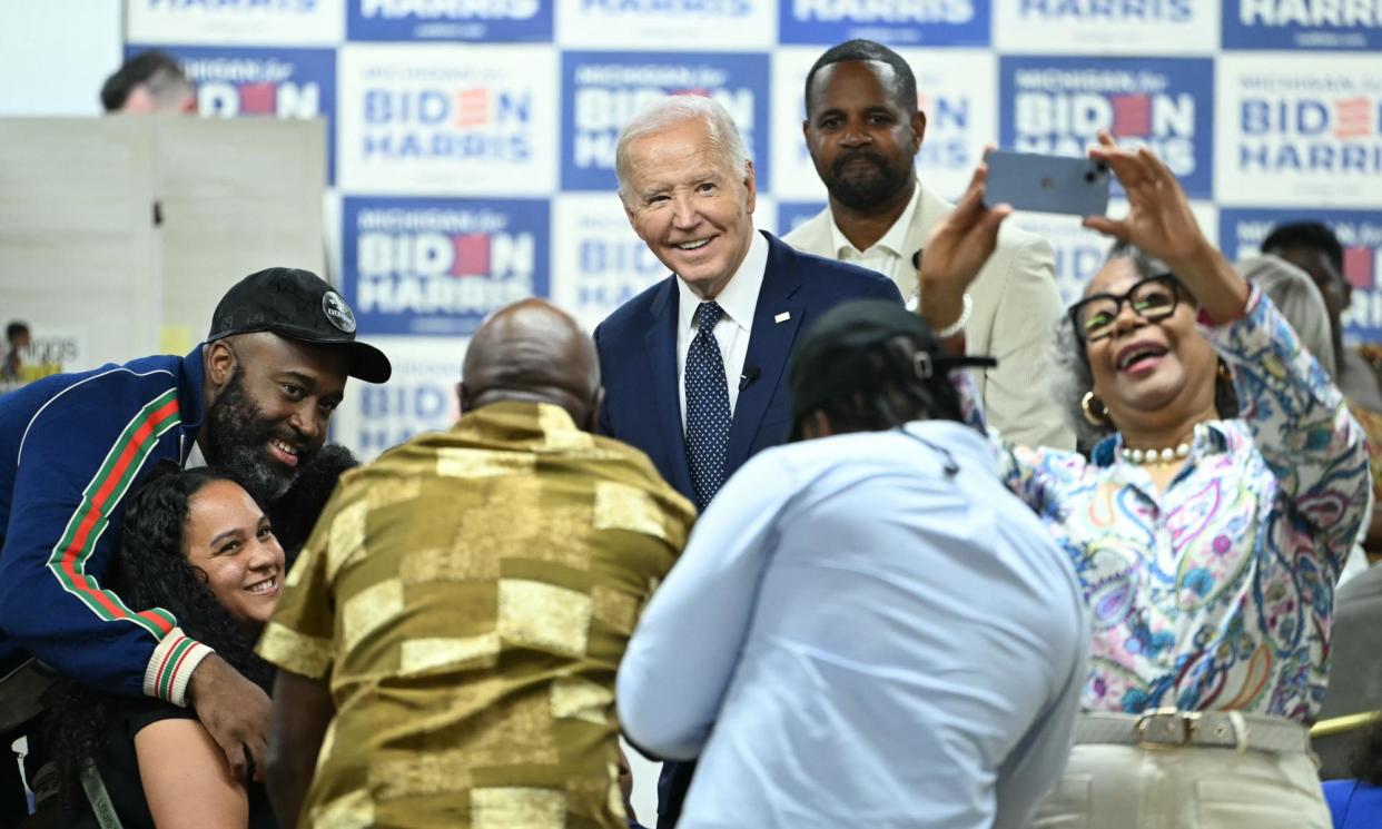 <span>Joe Biden takes photos with supporters during a campaign event at Cred Cafe in Detroit, Michigan, this week.</span><span>Photograph: Andrew Caballero-Reynolds/AFP/Getty Images</span>