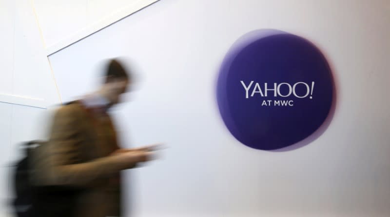 A man walks past a Yahoo logo during the Mobile World Congress in Barcelona, Spain, February 24, 2016. REUTERS/Albert Gea/File Photo