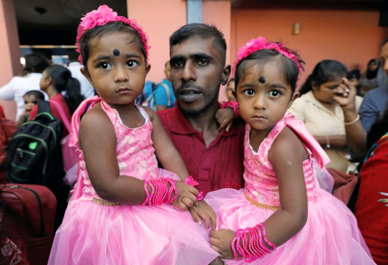 P.A Rishmi and P.A Rashni 2, look on during an event to attempt to break the world record for the biggest gathering of twins in Colombo