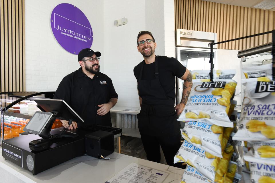 James Torres (left)  talks with chef Justin Rohloff, the founder and owner of newly opened Just Kitchen Jax, a fast-casual Mediterranean restaurant at 13423 Beach Blvd.