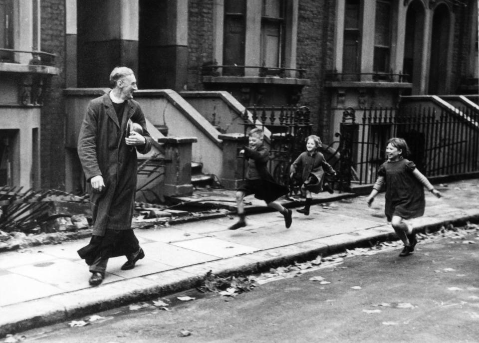 Children playfully run after a parson in 'Life of an East End Parson', 1940 (Bert Hardy/ Getty Images)