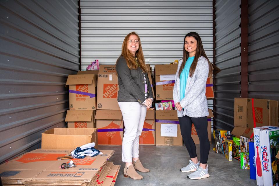 Price Crenshaw, the founder and former executive director, and Annamaria Tormey, the Clemson Hope Adopt a Classroom director, pose for a portrait in a storage unit Tuesday, November 12, 2019, with boxes of toys to be gifted to title 1 elementary school students.