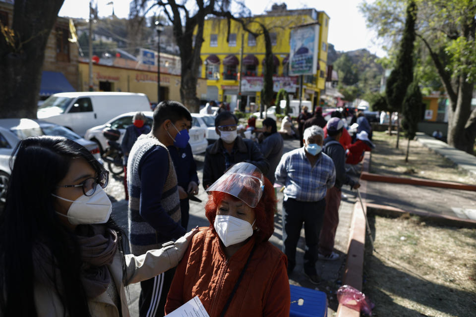 People over age 60 wait to get the AstraZeneca vaccine for COVID-19 as Mexico begins vaccinating its elderly population for the new coronavirus in the outlying Milpa Alta borough of Mexico City, Monday, Feb. 15, 2021. (AP Photo/Rebecca Blackwell)