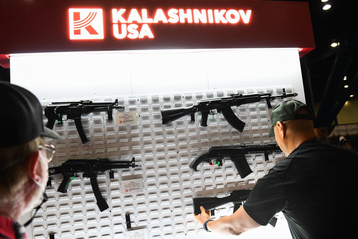 Attendees hold American-made AK-47-style 7.62mm semiautomatic rifles from Kalashnikov USA during the National Rifle Association's annual meeting in Houston in May. 