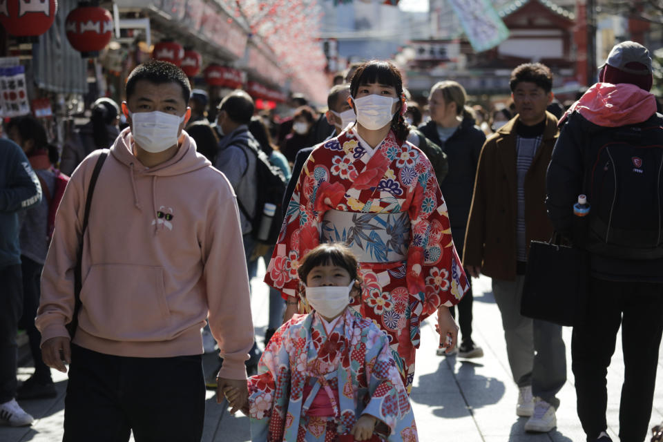 Tourists wear masks as they visit Sensoji Temple Thursday, Jan. 30, 2020, in Tokyo. The country began evacuating Japanese citizens on Wednesday from the Chinese city Wuhan hardest-hit by the virus. (AP Photo/Jae C. Hong)