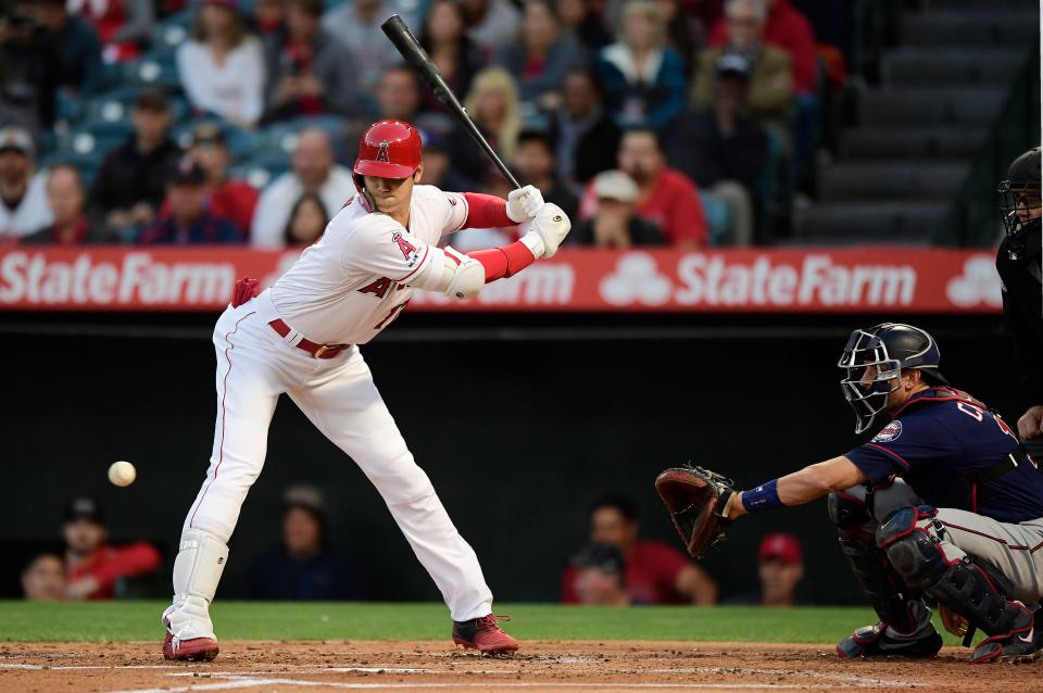 Los Angeles Angels' Shohei Ohtani, left, of Japan, avoids a close pitch for ball four during the first inning of a baseball game against the Minnesota Twins, Monday, May 20, 2019, in Anaheim, Calif. (AP Photo/Mark J. Terrill)
