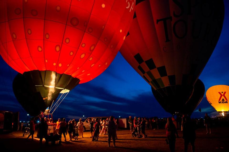 Hot air balloon pilots fire their burners to light up their balloons during the Gulf Coast Hot Air Balloon Festival at OWA in Foley, Alabama on Thursday, May 4, 2023.