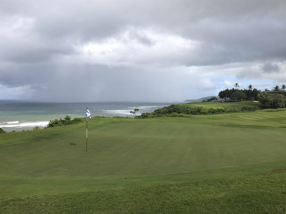 In this Nov. 16, 2018 photo, the green of the 14th hole at the Princeville Makai Club in Princeville, Hawaii looks back toward the tee box. The short par-4 hole plays across an inlet of the Pacific Ocean and above steep cliffs on the north shore of Kauai. (AP Photo/John Marshall)