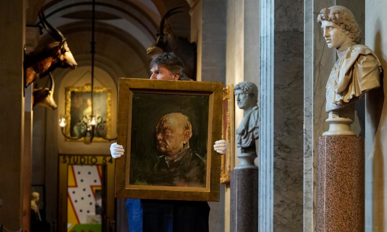 <span>A member of staff from Sotheby's poses for the media with a portrait of the former British prime minister Winston Churchill, painted by Graham Sutherland in 1954, at Blenheim Palace, Woodstock, England.</span><span>Photograph: Alastair Grant/AP</span>