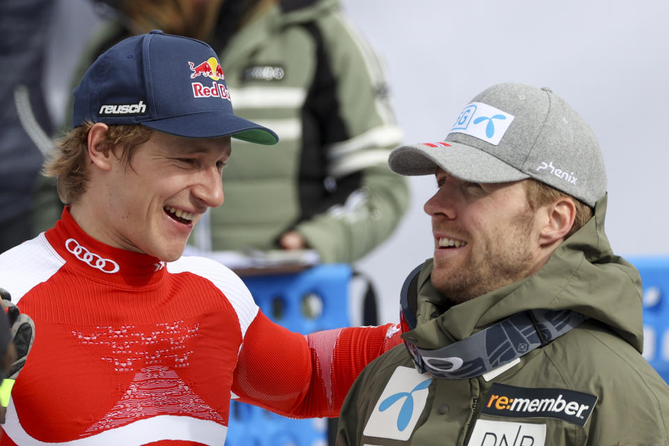 Switzerland's Marco Odermatt, left, and Norway's Aleksander Aamodt Kilde talk during an alpine ski, men's World Cup Finals downhill, in Courchevel, France, Wednesday, March 16, 2022. (AP Photo/Alessandro Trovati)