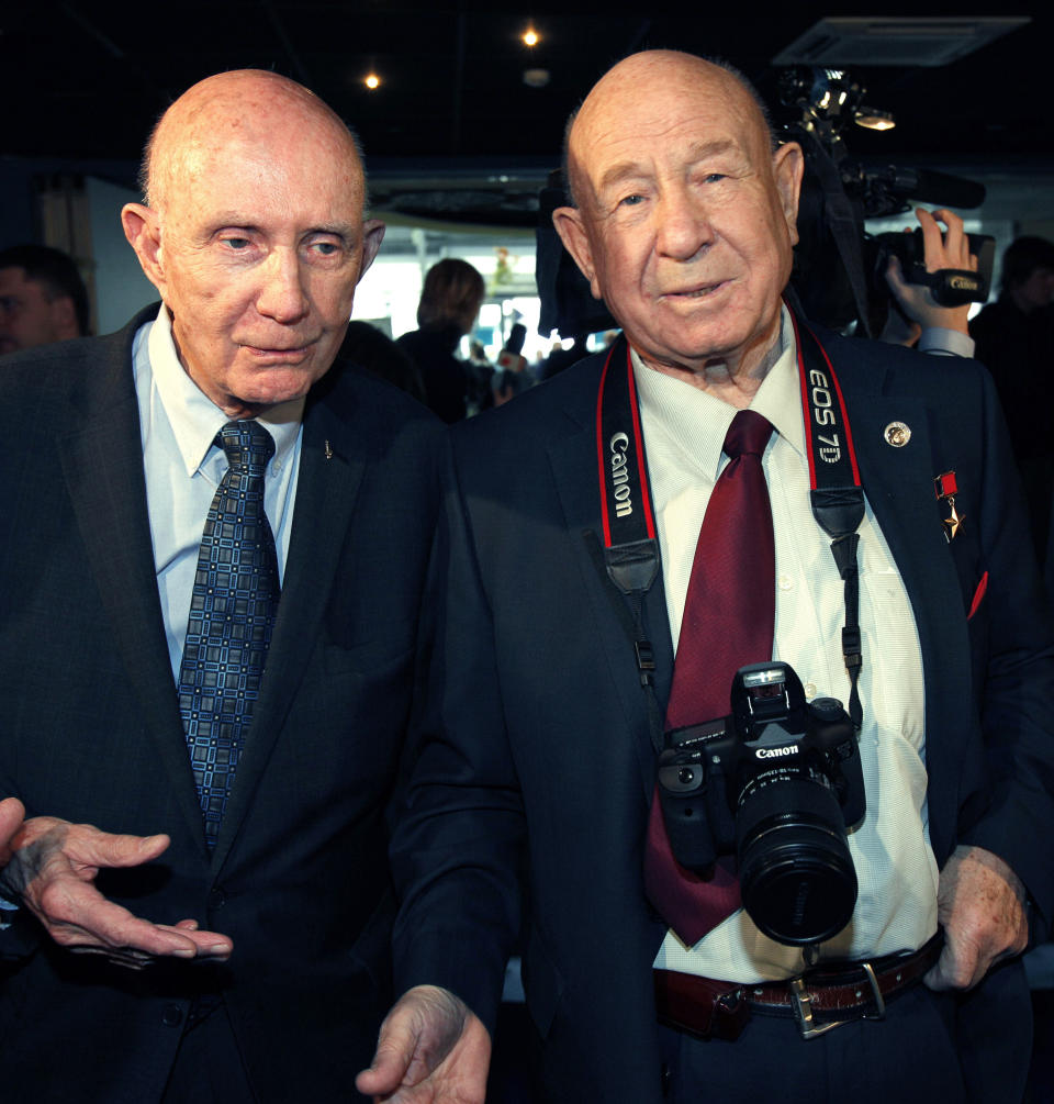 FILE - In this Monday, April 11, 2011 file photo, retired NASA astronaut Thomas Stafford, left, and retired Russian cosmonaut Alexei Leonov visit an exhibition dedicated to the 50th anniversary of the first man in space in Moscow, Russia. Alexei Leonov, the first human to walk in space, died in Moscow on Friday, Oct. 11, 2019. He was 85. (AP Photo/Alexander Zemlianichenko, File)