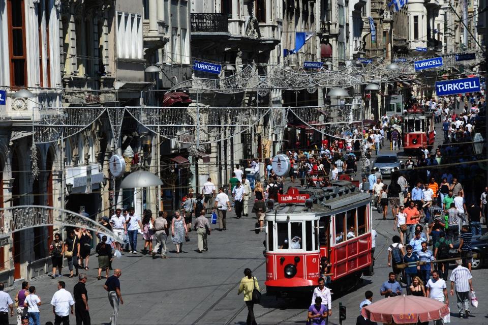 A tramway heads from Istiklal Avenue to the Taksim Square, considered the city's main business and entertainment center that hosts a monument to Turkey's ubiquitous national hero, Mustafa Kemal Ataturk, and other founders of the modern Turkish Republic, in Istanbul, Turkey, Monday, Oct. 28, 2013. Last summer, Istanbul’s Taksim Square was the scene of violent confrontations between police and protesters. But protests have faded, and contrary to some lingering perceptions, it’s quite calm now _ except for the normal hustle and bustle found in this vibrant city. And it’s as safe for tourists as it ever was. Istanbul is a thoroughly modern place, but it traces its roots back to 660 B.C. It’s the former seat of the opulent Byzantine and Ottoman empires and is divided into European and Asian sides by the Bosporus Strait, offering a wealth of history and stunning scenery.(AP Photo)