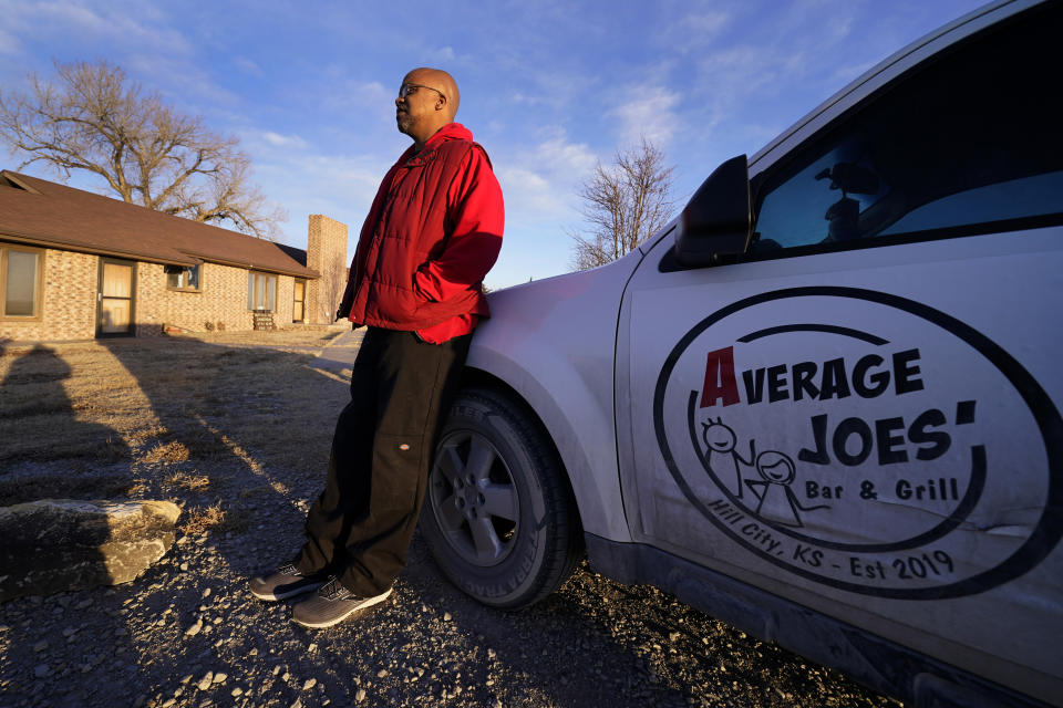 Lateef Dowdell stands on land once belonging to his uncle Gil Alexander, who was the last active Black farmer in the community of Nicodemus, Kan., Thursday, Jan. 14, 2021. Dowdell moved back to Nicodemus, a settlement founded by former slaves known as "exodusters" in the 1870s, several years earlier to take over the farm after his uncle died, but soon after lost most of the land when the bank foreclosed. New legislation in Congress aims to remedy historical inequities in government farm programs that have helped reduce the number of Black farmers in the United States from about a million in 1920 to less than 50,000 today. (AP Photo/Charlie Riedel)