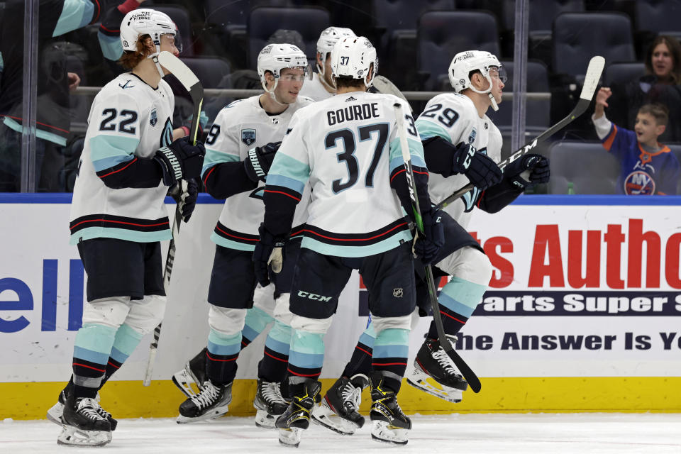 Seattle Kraken defenseman Vince Dunn reacts with teammates after scoring a goal in the third period of an NHL hockey game against the New York Islanders on Wednesday, Feb. 2, 2022, in Elmont, N.Y. The Kraken won 3-0. (AP Photo/Adam Hunger)