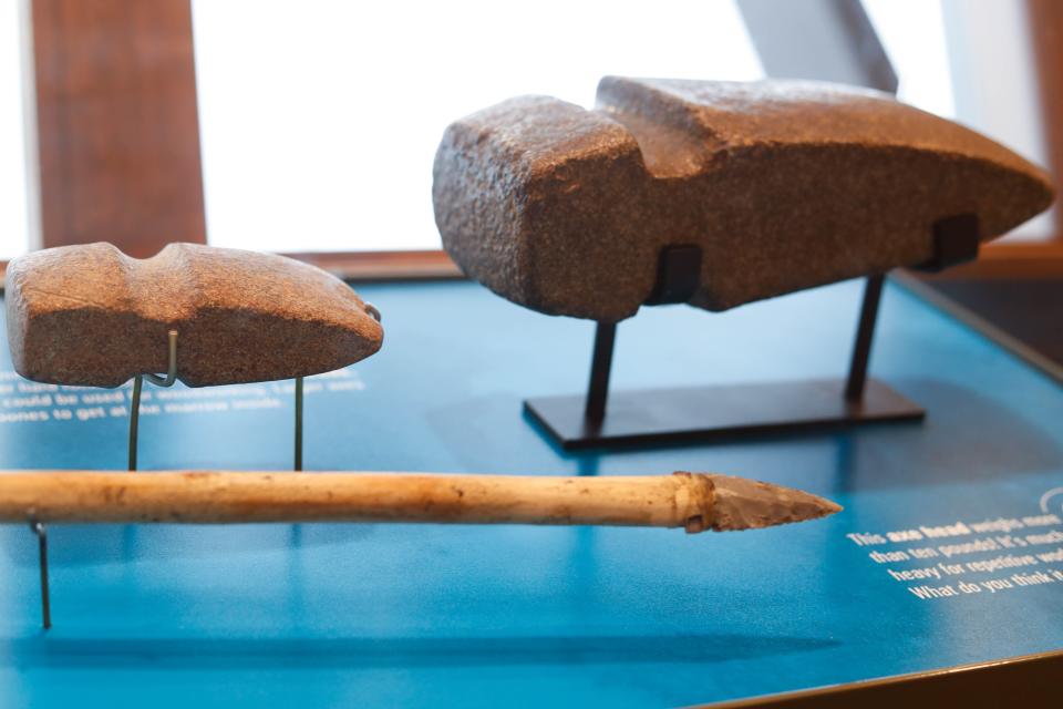 Stone arrowheads and projectile points sit on display at the new exhibit at Jester Park Nature Center in Granger on Tuesday, Nov. 29, 2022. The large ax head on the right was donated by Glen Keeling. It was found on his grandfather's property, which now makes up a portion of Yellow Banks Park in Pleasant Hill.