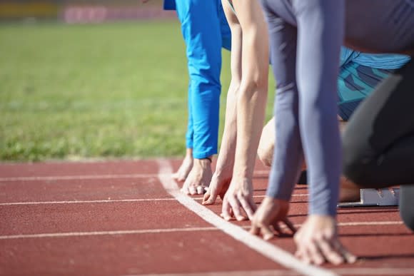 Three runners on their marks before a race.