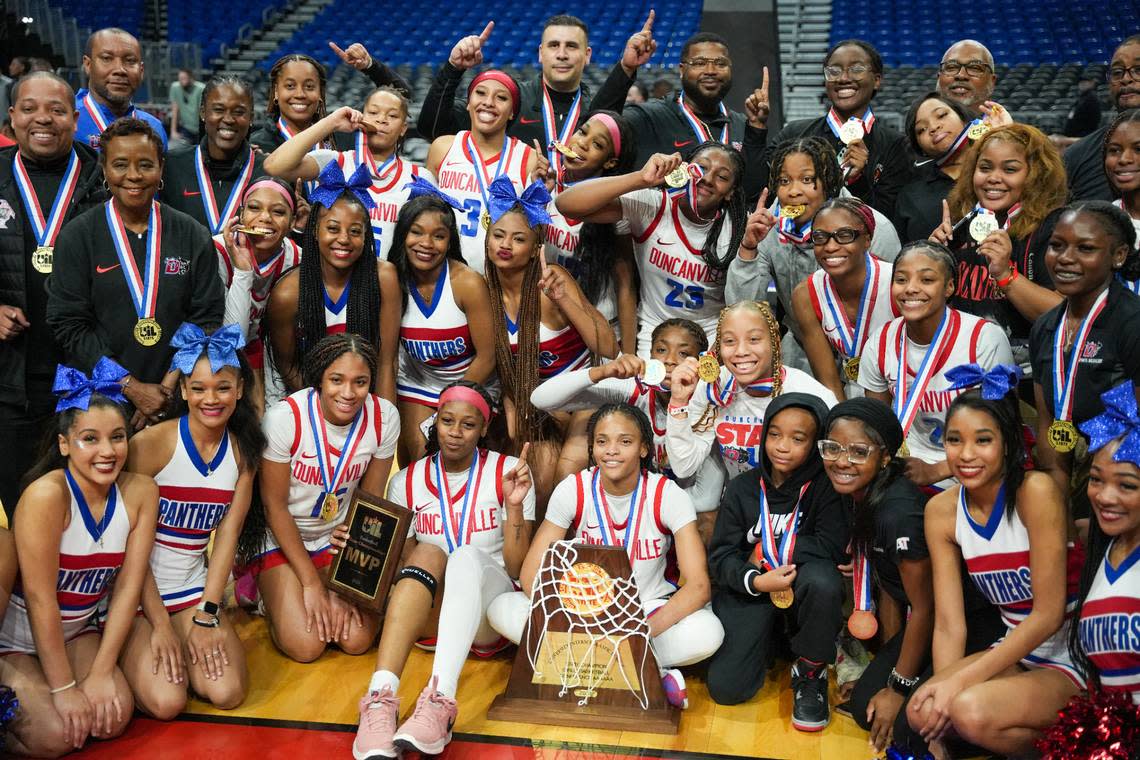 The Duncanville girls basketball team poses with its hardware after defeating South Grand Prairie in the Class 6A state championship game on Saturday, March 2, 2024 at the Alamodome in San Antonio, Texas.