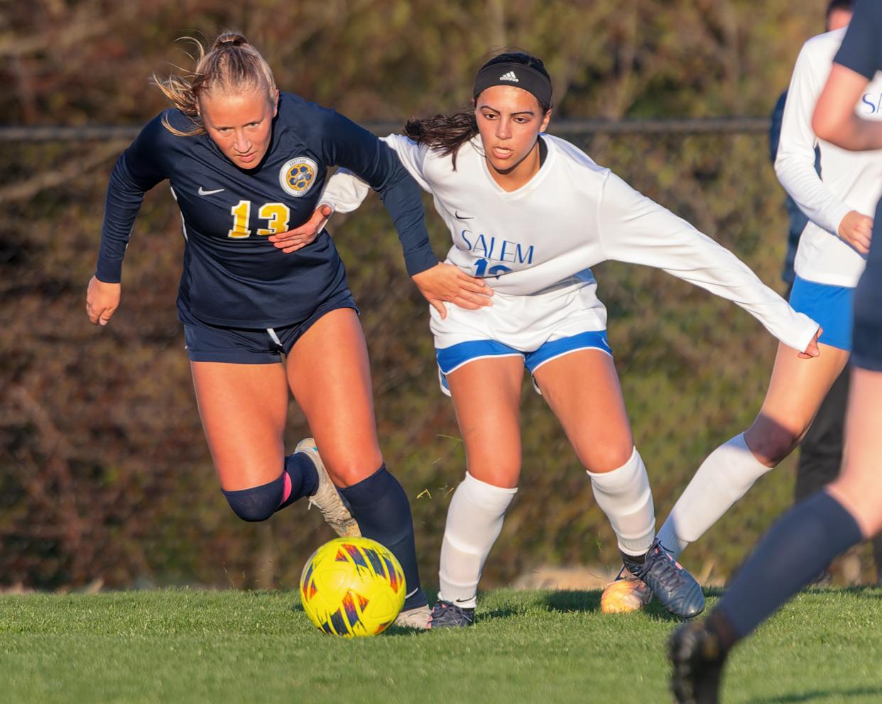 Hartland's Emma Kastamo (13), who scored Hartland's only goal during a 1-1 tie against Salem, battles Alik Yeremian for the ball Tuesday, April 23, 2024.