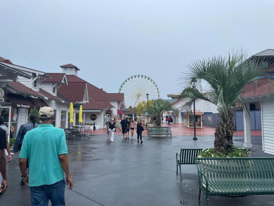 People walk around Broadway At The Beach Wednesday, Aug. 30. The shopping center is allowing vendors to decide if they stay open Thursday, Aug. 31.