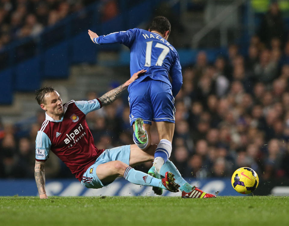 Chelsea's Eden Hazard, has the ball taken from him by West Ham's Matthew Taylor during their English Premier League soccer match between Chelsea and West Ham United at Stamford Bridge stadium in London, Wednesday, Jan. 29, 2014.(AP Photo/Alastair Grant)