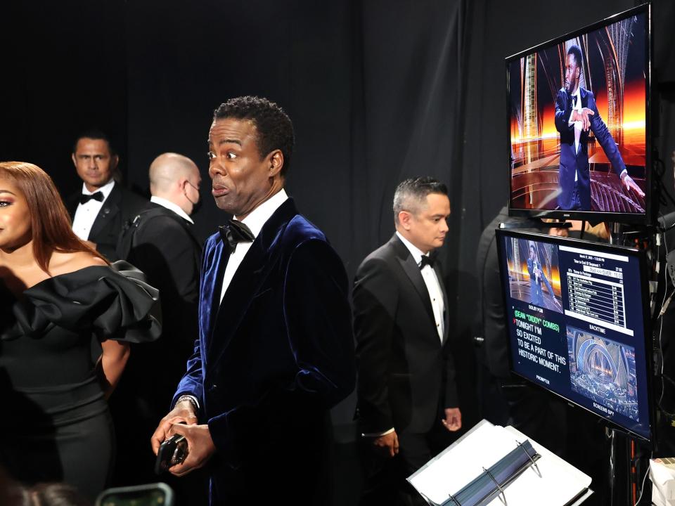 (L-R) In this handout photo provided by A.M.P.A.S., Elliot Page, J.K. Simmons and Chris Rock are seen backstage during the 94th Annual Academy Awards at Dolby Theatre on March 27, 2022 in Hollywood, California.