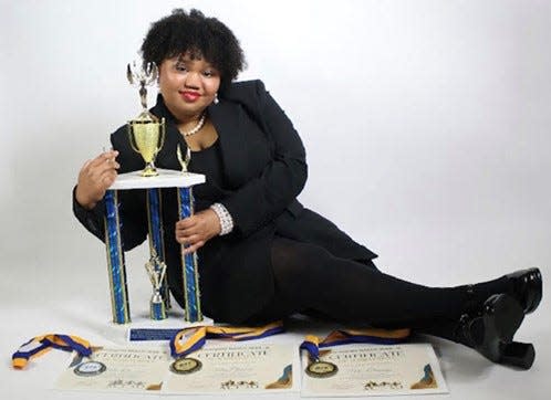 Mia Clemons, 15, poses with several awards won during the Coraopolis NAACP ACT-SO competition. After winning the local awards, Clemons went to the national competition and earned a silver medal while in Boston.