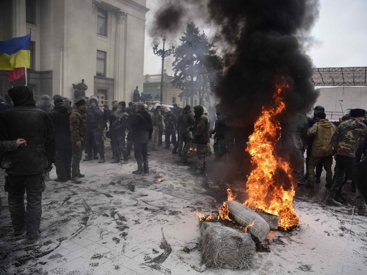 Protesters burn tyres near the Parliament building as riot policemen gather at a camp of supporters of Ukrainian opposition figure and Georgian former President Mikheil Saakashvili: Reuters