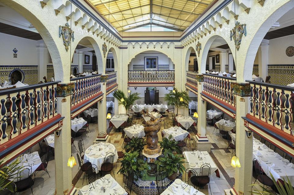 The Patio Dining Room, a grand space with a balcony that wraps around a double-height space, putting diners on two levels at the original Columbia Restaurant in Ybor City. That part of the building was constructed in 1937 under the direction of Casimiro Hernandez Jr., who became the owner when his father died in 1930. He worked with architect Iv de Minicis of Rimini, Italy.