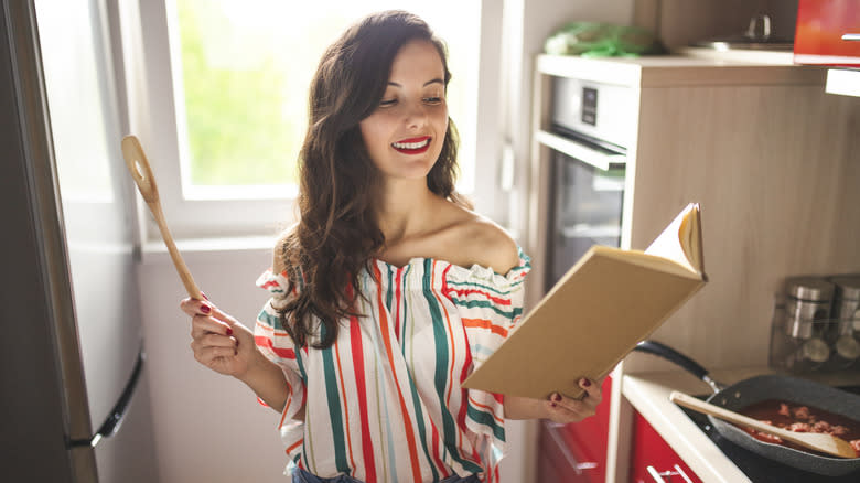 Woman reading cookbook