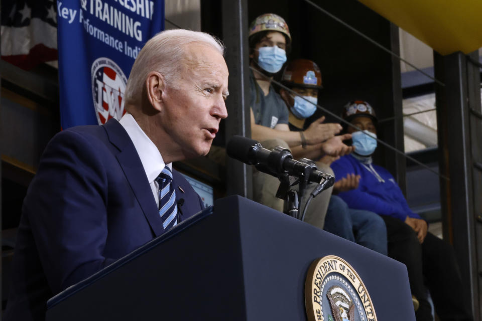 Ironworkers Local 5 sit high on a training platform as they listen to President Biden deliver remarks about project labor agreements at the local on February 04, 2022 in Upper Marlboro, Maryland. (Photo by Chip Somodevilla/Getty Images)