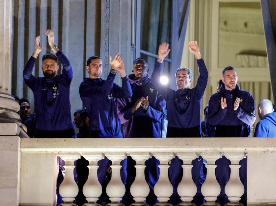 The team appeared on the balcony of the Hotel de Crillon (AFP via Getty Images)