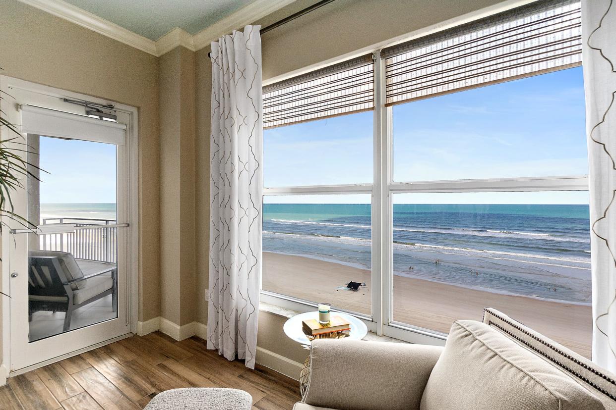 An impressive wall of sliding glass doors serves as the focal point to bring direct oceanfront views into this impressive St.Kitts penthouse.