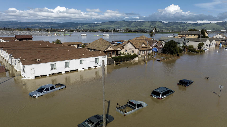 Floodwaters surround homes and vehicles in Pajaro, Monterey County, Calif., March 13, 2023. / Credit: Noah Berger/AP