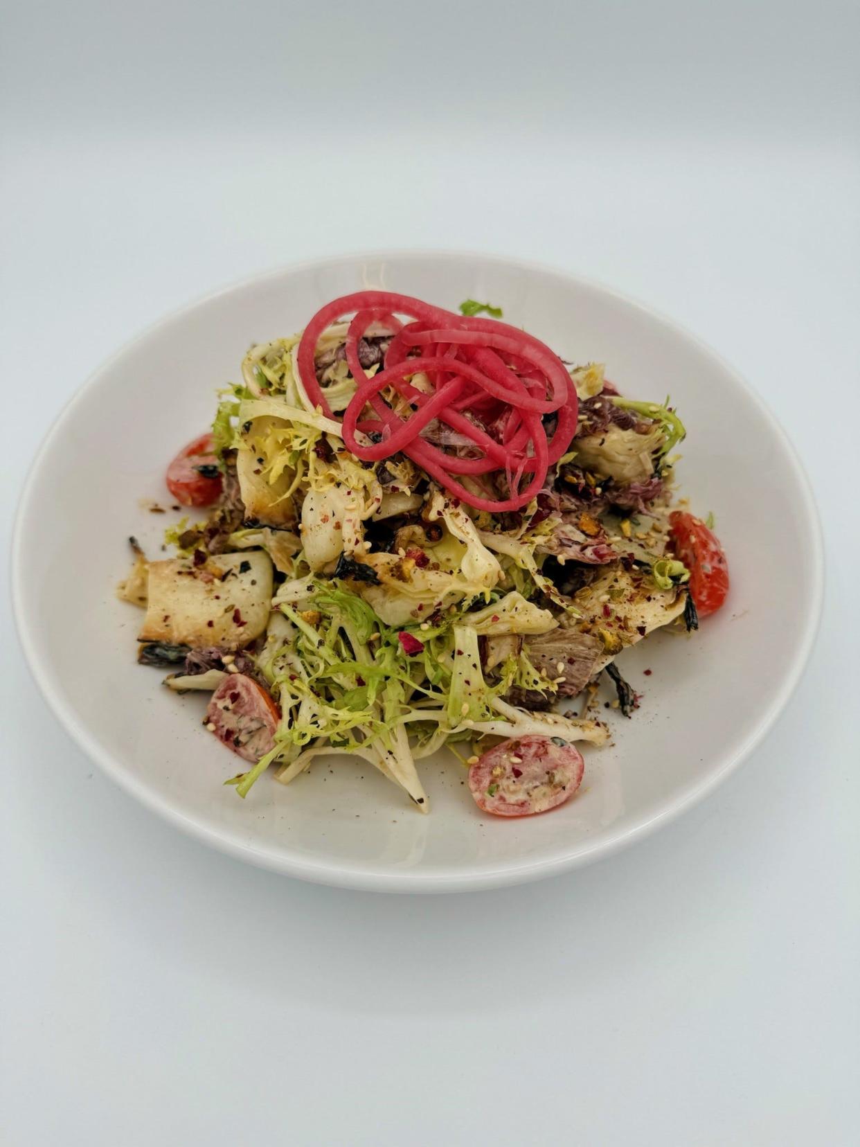 The Providence chop salad with grilled chicories, soprano vinaigrette, and crispy white beans at Prime & Providence, the new steakhouse from Dominic Iannerelli and Cory Gorley in West Des Moines.