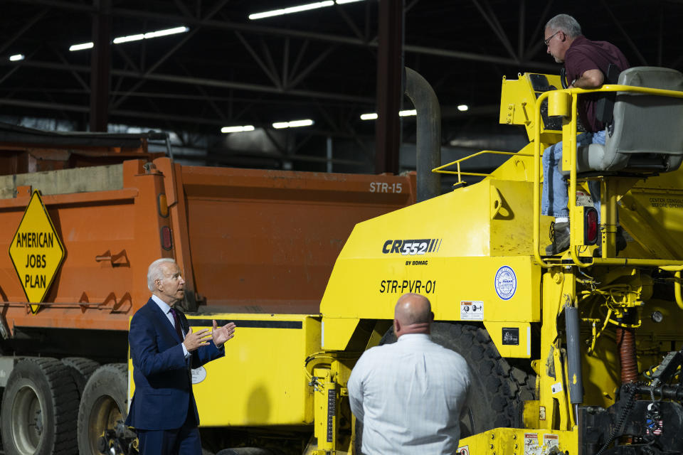 President Joe Biden participates in a tour of the La Crosse Municipal Transit Authority with Adam Lorentz, Transit Manager, La Crosse Municipal Transit Utility, right, and Mike La Fleur, the superintendent of streets for the MTU, center, Tuesday, June 29, 2021, in La Crosse, Wis. (AP Photo/Evan Vucci)