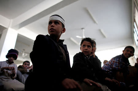 Boys wait to perform prayers at the mosque of The al-Shawkani Foundation for Orphans Care in Sanaa, Yemen, December 25, 2016. REUTERS/Khaled Abdullah