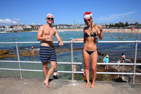 Max Bennett and Olivia Tilton, from London pose in front of Bondi Beach.