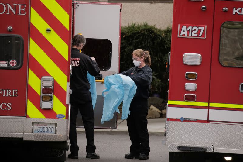 Medics prepare to transfer a patient on a stretcher to an ambulance at the Life Care Center of Kirkland, the long-term care facility linked to the two of three confirmed coronavirus cases in the state, in Kirkland