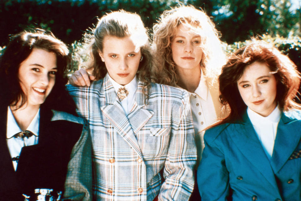 <p>The cool girl style of the <em>Heathers </em>(and Veronica aka Winona Ryder) was swoon-worthy, even for the late '80s (the acid wash and shoulder pads, ahhhh!!!). But here, think crisp blazers, chic plaids, and full bouncy hair.</p>